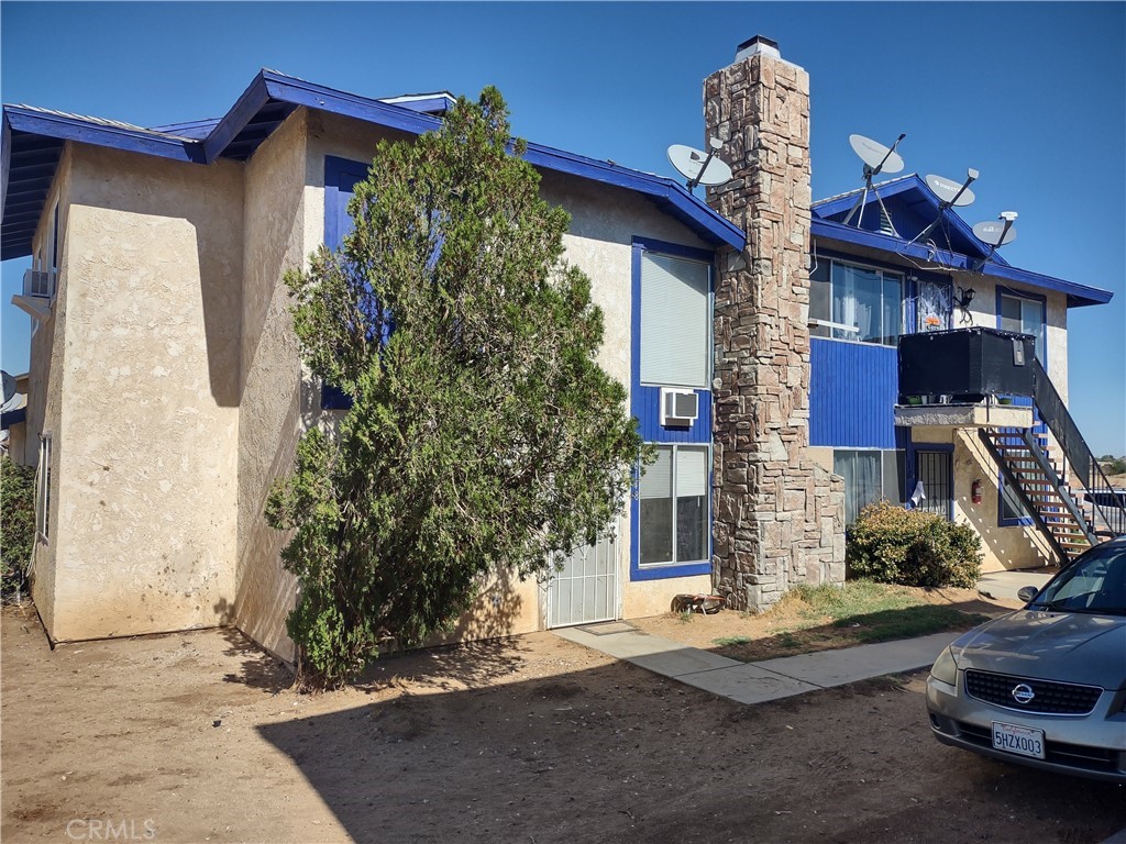 18148 Poinciana Road Adelanto, CA 92301 - Photo 1 of 1 a front view of a house with garden
