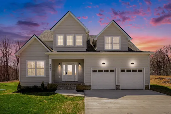 a front view of a house with a yard