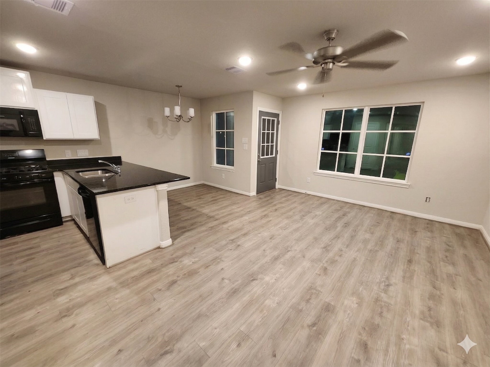 422 3rd Street Rosenberg, TX 77471 - Photo 3 of 14 a kitchen with stainless steel appliances granite countertop a stove and a large window