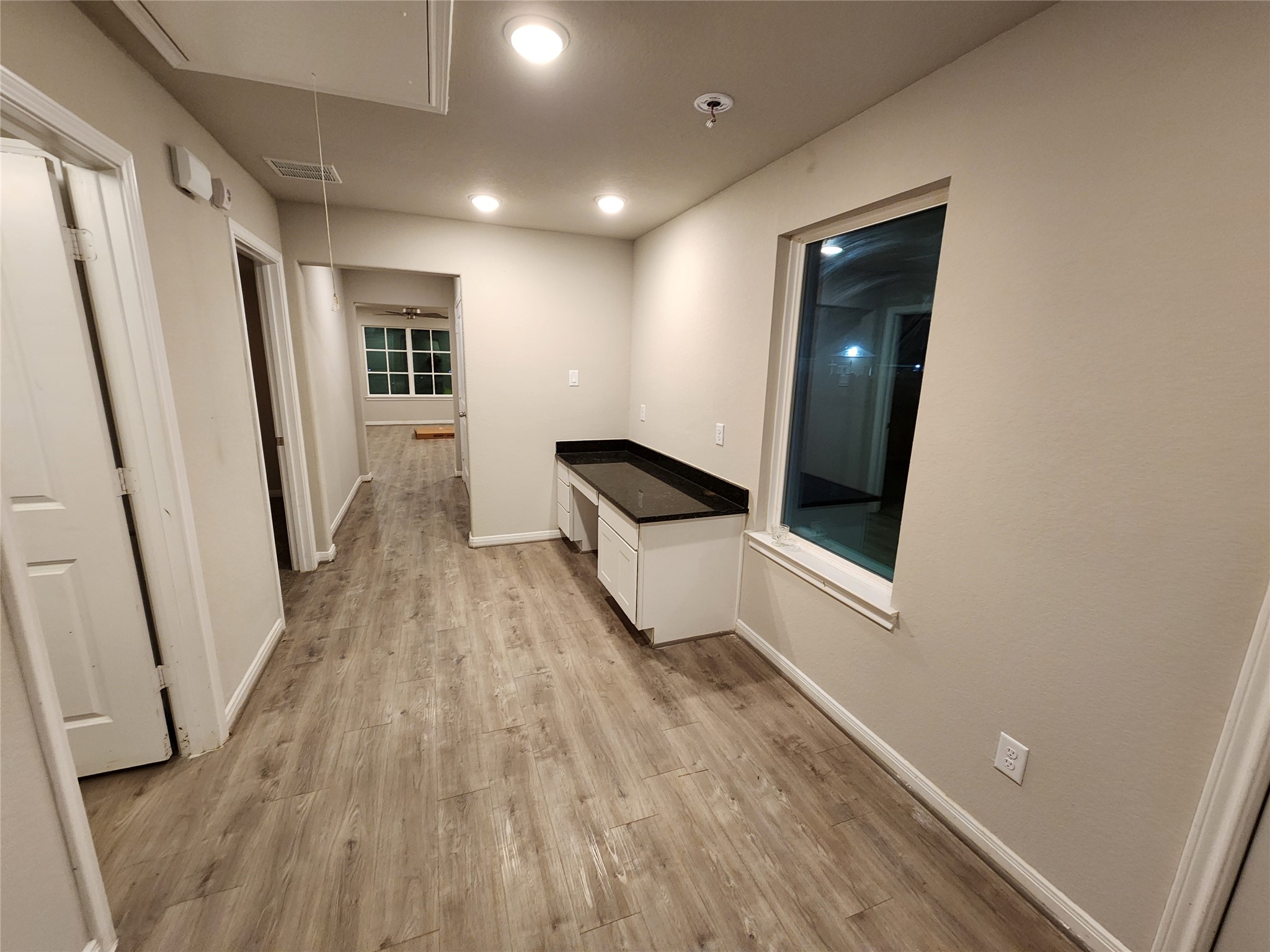 422 3rd Street Rosenberg, TX 77471 - Photo 9 of 14 wooden floor in an empty room with a mirror