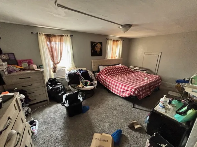 a bedroom with bed and a window