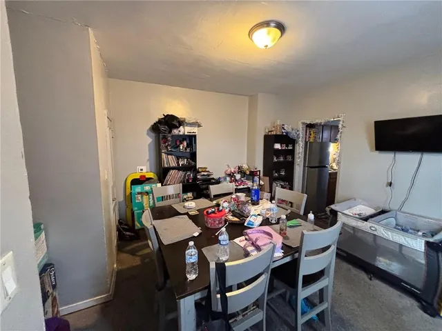 a view of a dining room with furniture and a chandelier