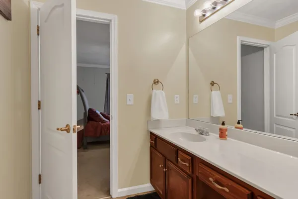a en suite bathroom with a sink and mirror