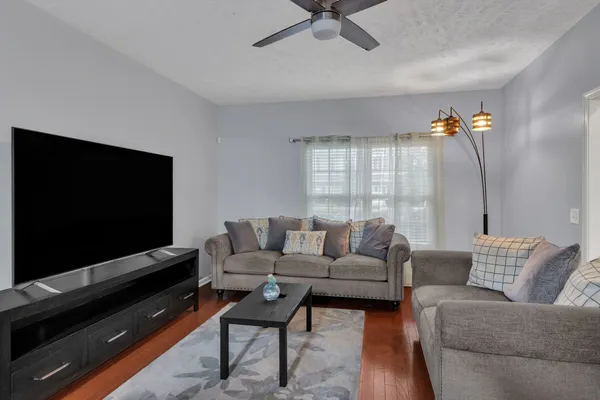 a living room with furniture and a flat screen tv