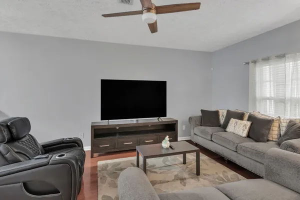 a living room with furniture and a flat screen tv