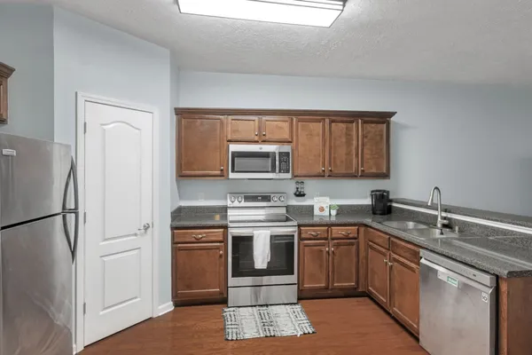 a kitchen with a sink stove and refrigerator