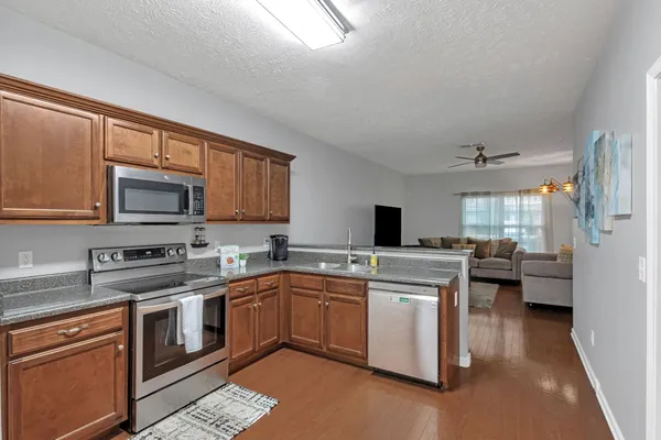 a kitchen with a sink stove and microwave