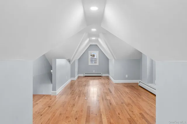 a view of an empty room and wooden floor