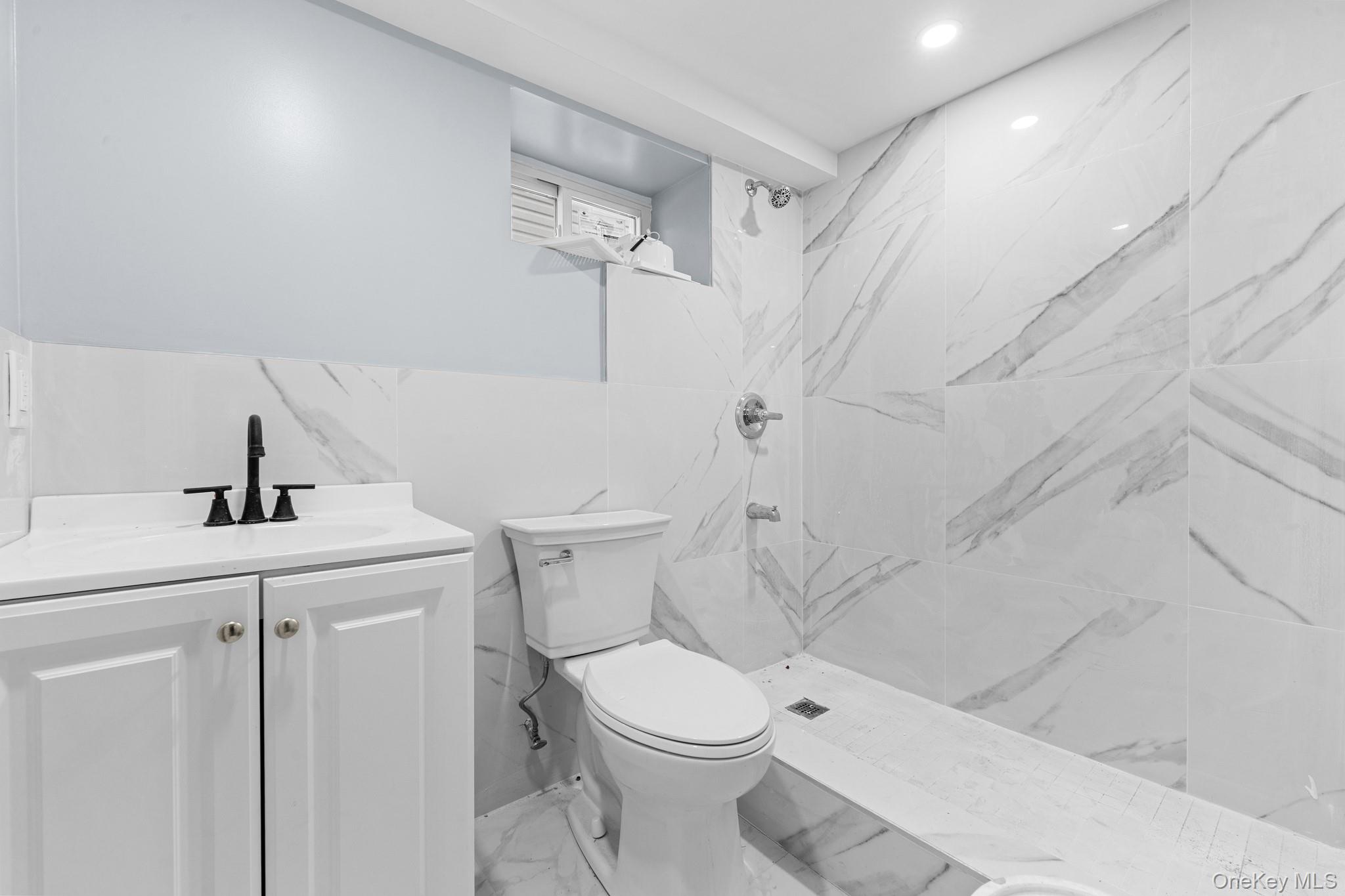 142-35 Sutter Avenue Queens, NY 11436 - Photo 16 of 21 a white toilet sitting next to a bathroom sink