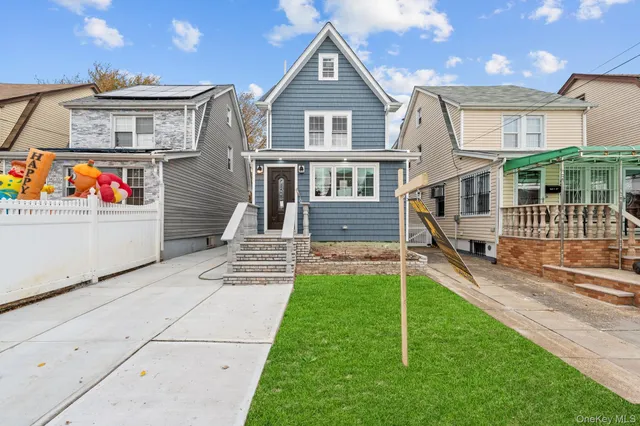 a view of a house with a yard and a car park table