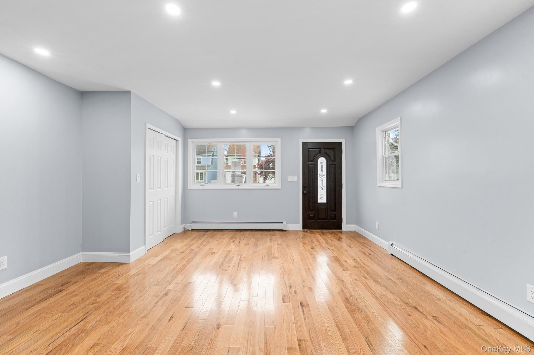 142-35 Sutter Avenue Queens, NY 11436 - Photo 7 of 21 a view of a big room with wooden floor and windows