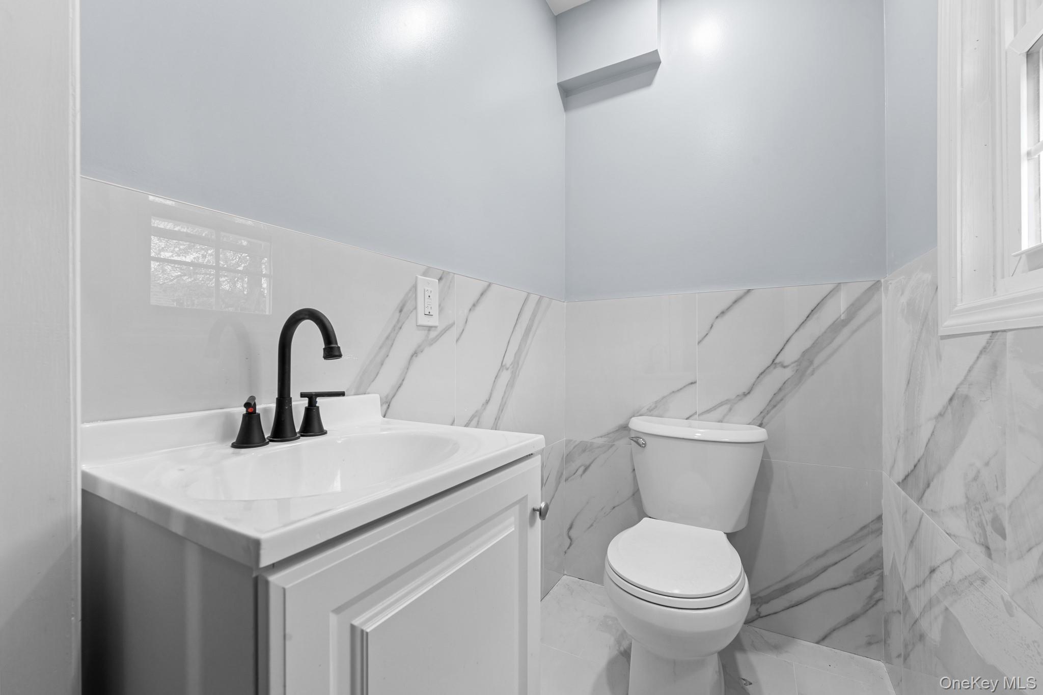 142-35 Sutter Avenue Queens, NY 11436 - Photo 8 of 21 a bathroom with a toilet sink and a mirror