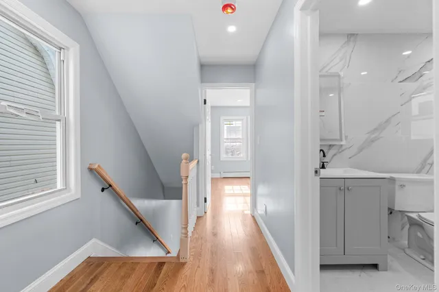 a view of entryway and hall with wooden floor