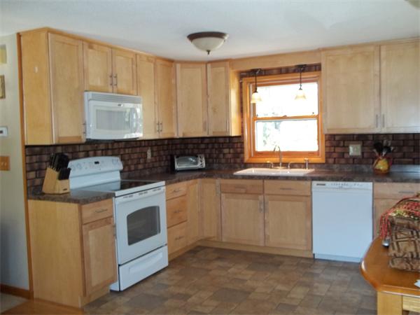 125 Dunn Road Ashburnham, MA 01430 - Photo 3 of 18 a kitchen with granite countertop white cabinets sink and white appliances