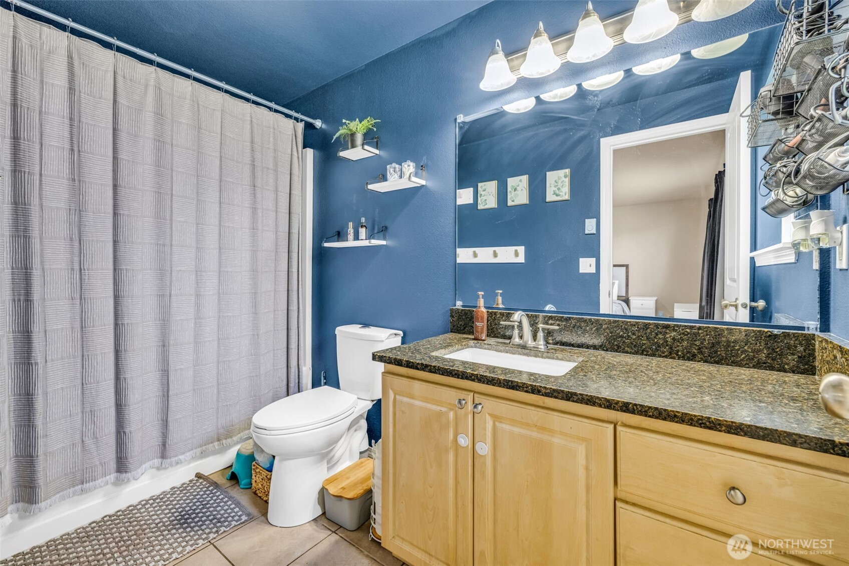 10313 School Land Road Southwest Rochester, WA 98579 - Photo 25 of 40 a bathroom with a granite countertop sink and a mirror