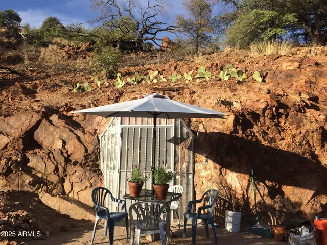 a view of a chairs and table in patio