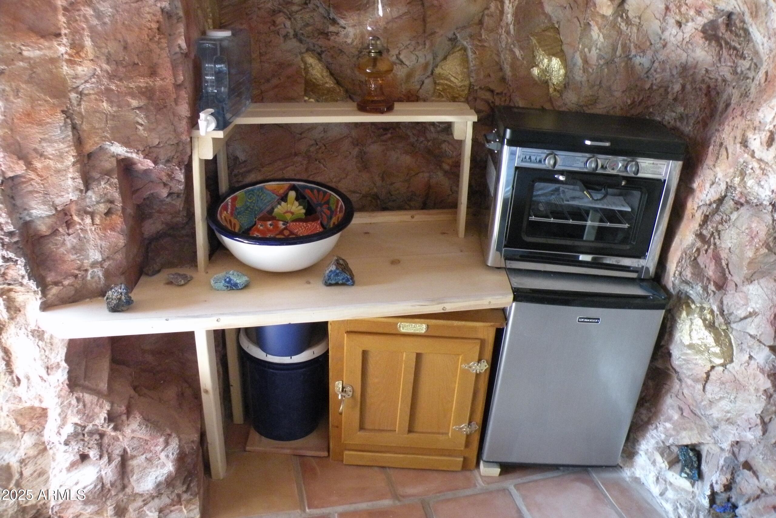 127 High Road, Unit 42 Bisbee, AZ 85603 - Photo 12 of 38 a close view of water heater and wooden cabinets