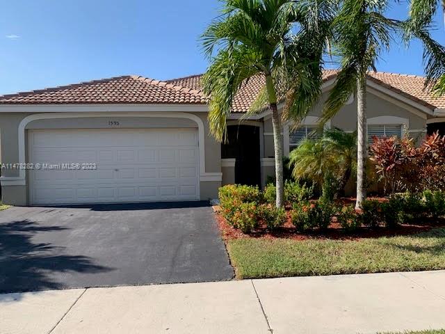 Savanna Weston, FL 33327 - Photo 1 of 21 a front view of a house with a garden