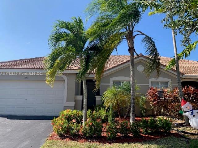 Savanna Weston, FL 33327 - Photo 2 of 21 a front view of a house with a yard