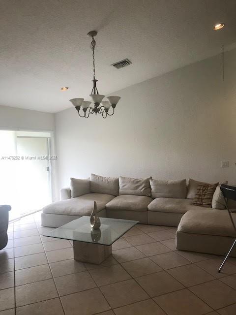 Savanna Weston, FL 33327 - Photo 6 of 21 a living room with furniture and a chandelier