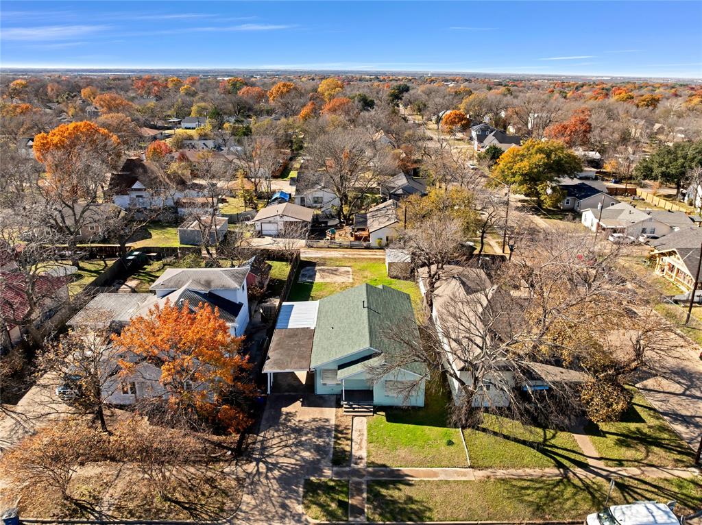 907 Southwest Main Street Ennis, TX 75119 - Photo 20 of 28 an aerial view of residential houses with outdoor space