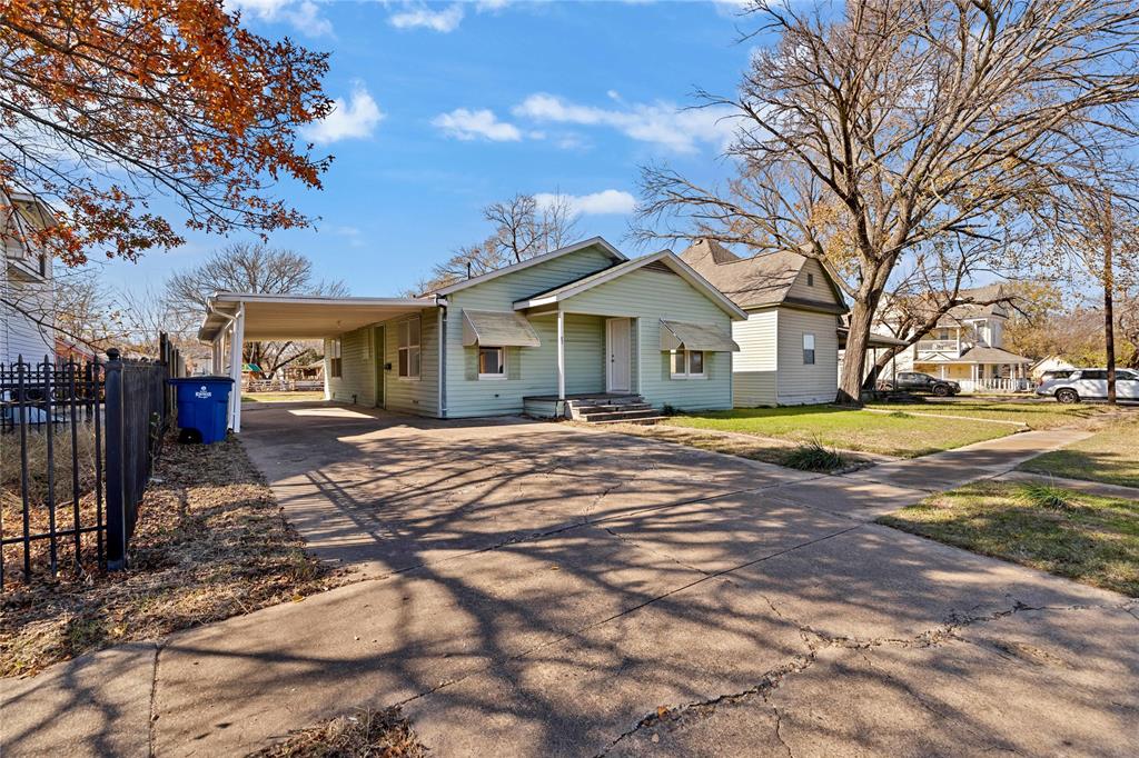 907 Southwest Main Street Ennis, TX 75119 - Photo 2 of 28 a front view of a house with a yard