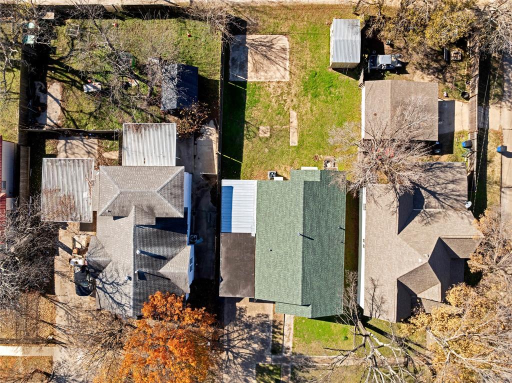 907 Southwest Main Street Ennis, TX 75119 - Photo 24 of 28 an aerial view of residential houses with outdoor space