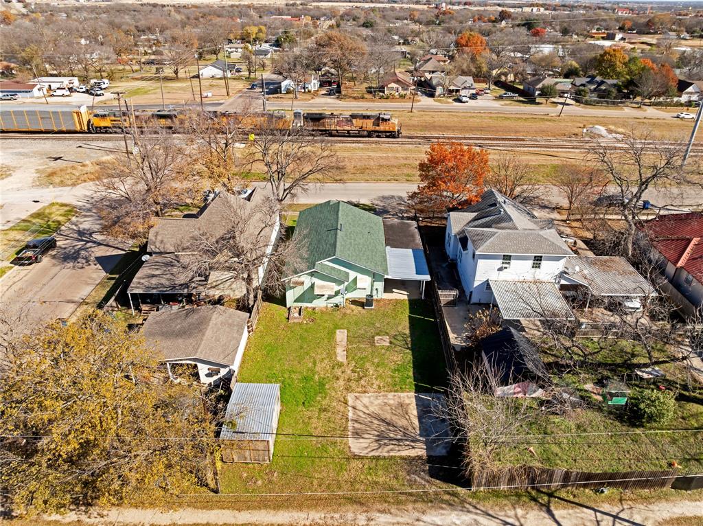 907 Southwest Main Street Ennis, TX 75119 - Photo 25 of 28 an aerial view of residential houses with outdoor space