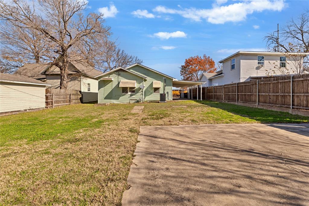 907 Southwest Main Street Ennis, TX 75119 - Photo 27 of 28 a view of a house with a yard