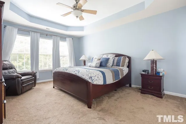 a spacious bedroom with a bed and a couch