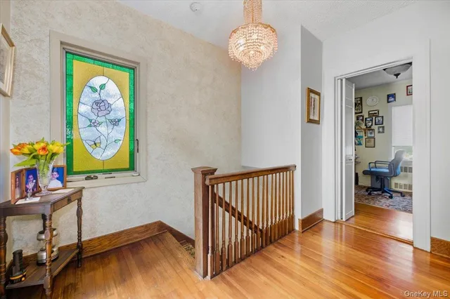 a view of a room with wooden floor and window
