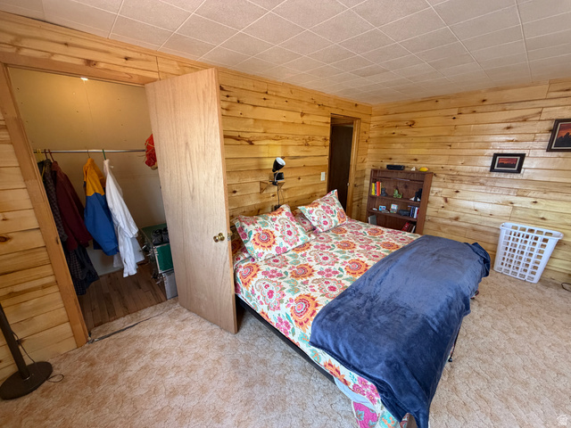 358 South Sky Drive Torrey, UT 84775 - Photo 29 of 82 Bedroom featuring wood-paneled walls and a textured ceiling