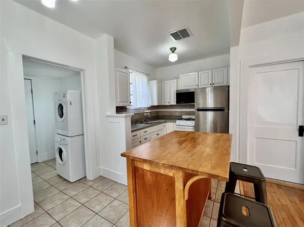 a kitchen with stainless steel appliances a refrigerator sink and microwave