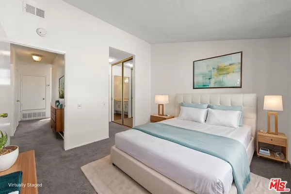 a bedroom with a bed and a couch