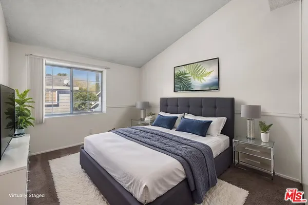 a bedroom with bed and window