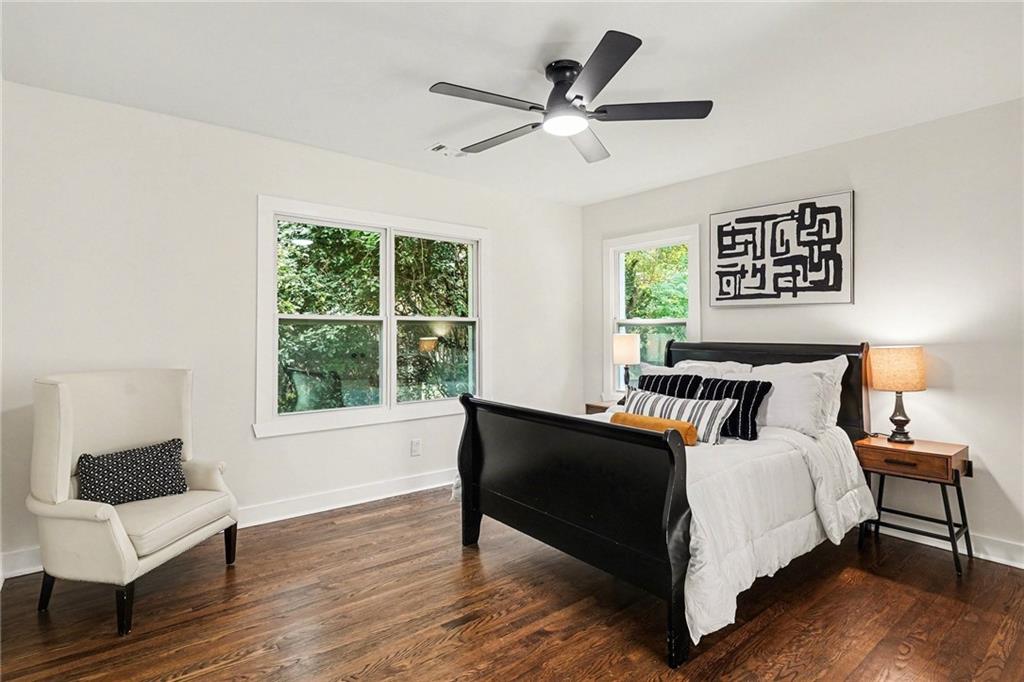 1275 Westridge Road Southwest Atlanta, GA 30311 - Photo 13 of 34 a bedroom with a bed and wooden floor