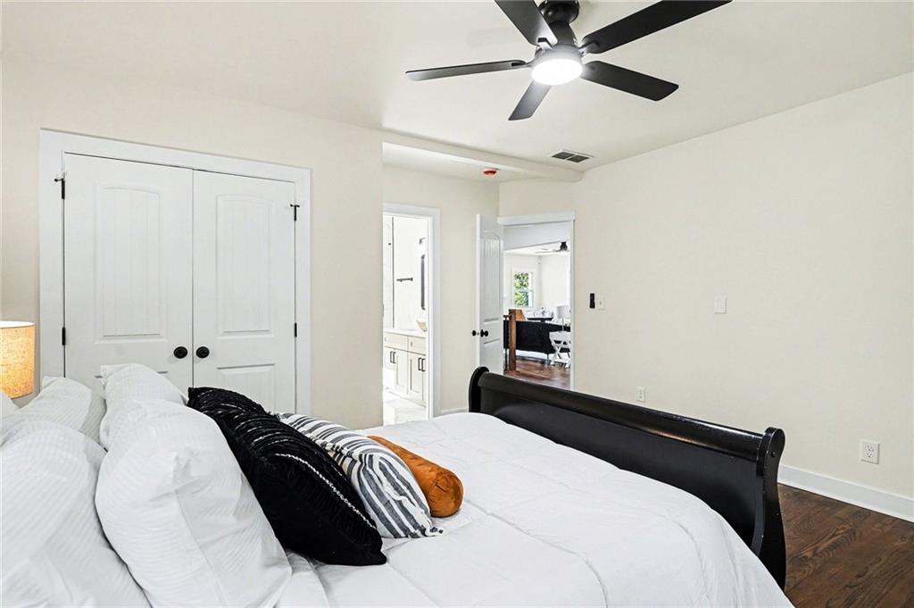 1275 Westridge Road Southwest Atlanta, GA 30311 - Photo 14 of 34 a bedroom with a bed and a chandelier