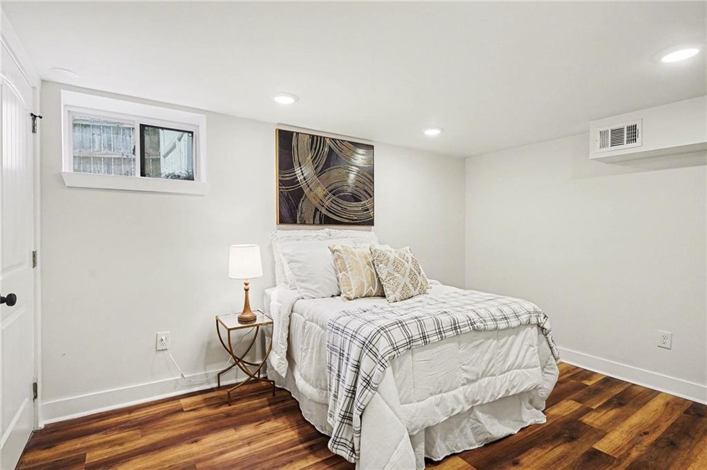 1275 Westridge Road Southwest Atlanta, GA 30311 - Photo 16 of 34 a bedroom with a bed and a painting on the wall