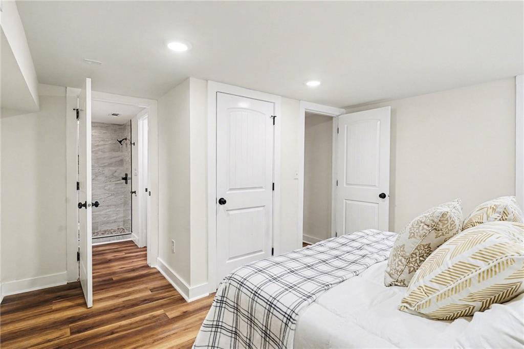 1275 Westridge Road Southwest Atlanta, GA 30311 - Photo 17 of 34 a bedroom with a bed and wooden floor