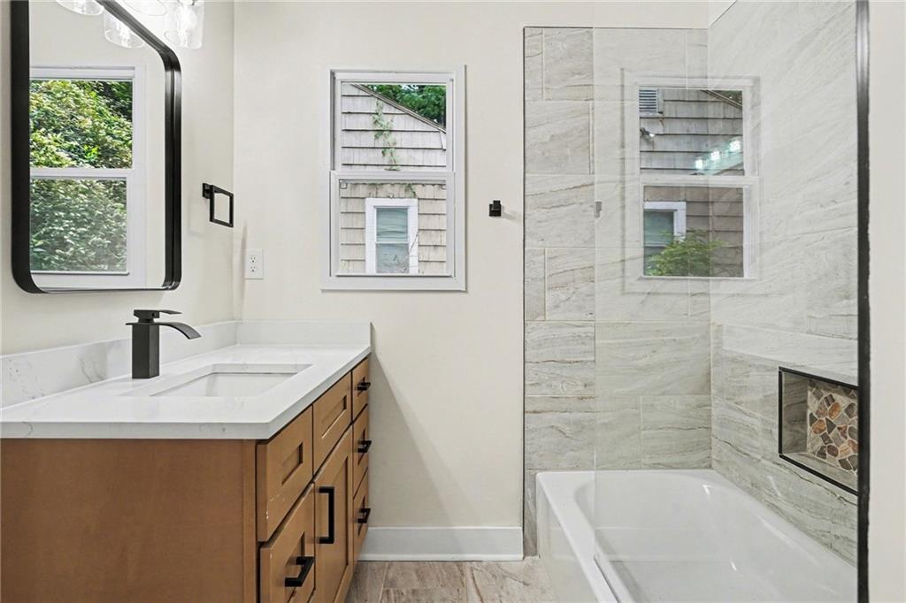 1275 Westridge Road Southwest Atlanta, GA 30311 - Photo 20 of 34 a bathroom with a sink a vanity and a bathtub