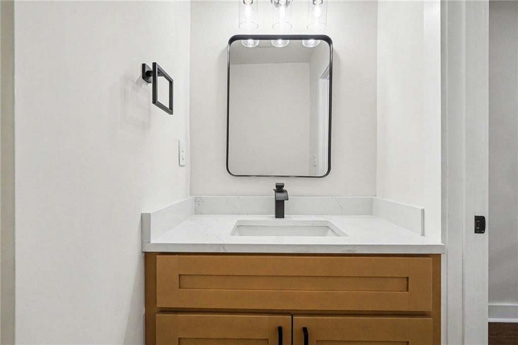 1275 Westridge Road Southwest Atlanta, GA 30311 - Photo 22 of 34 a bathroom with a sink vanity and a mirror