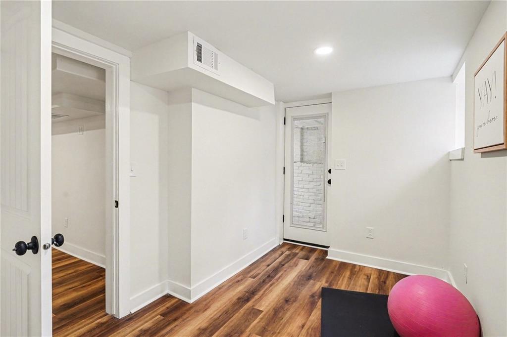 1275 Westridge Road Southwest Atlanta, GA 30311 - Photo 24 of 34 a view of a room with wooden floor and closet