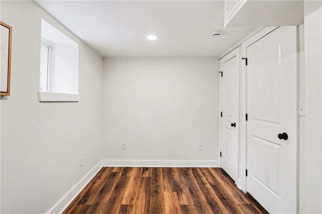 1275 Westridge Road Southwest Atlanta, GA 30311 - Photo 25 of 34 a view of a small space with wooden floor and a window