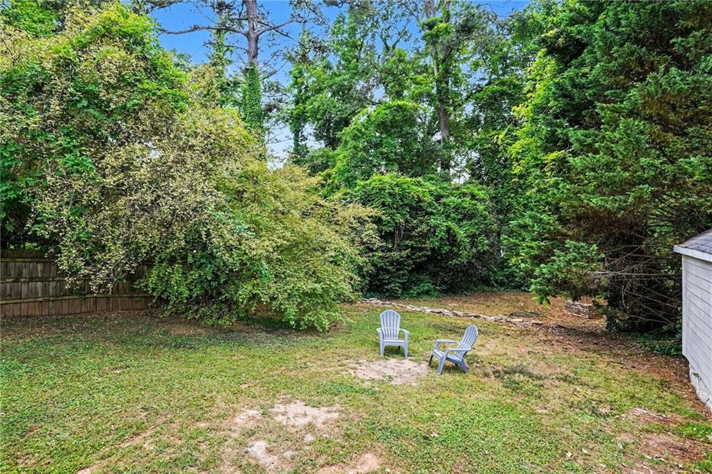 1275 Westridge Road Southwest Atlanta, GA 30311 - Photo 29 of 34 a wooden bench sitting in the middle of a yard