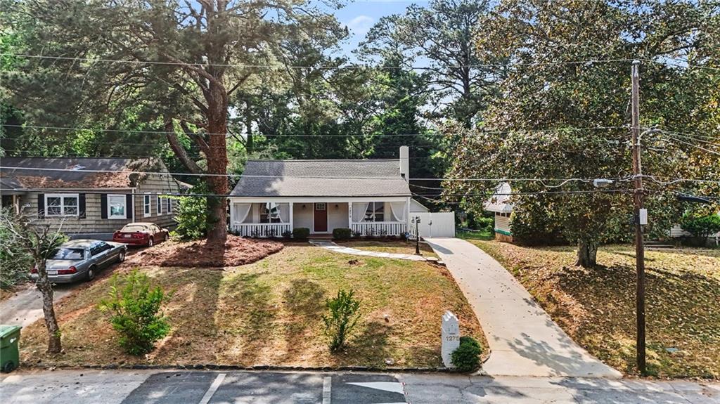 1275 Westridge Road Southwest Atlanta, GA 30311 - Photo 31 of 34 a view of a house with yard and covered with trees