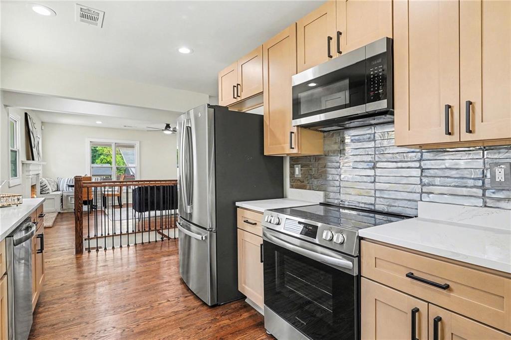 1275 Westridge Road Southwest Atlanta, GA 30311 - Photo 8 of 34 a kitchen with stainless steel appliances a stove microwave and refrigerator