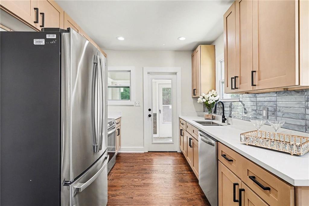 1275 Westridge Road Southwest Atlanta, GA 30311 - Photo 9 of 34 a kitchen with stainless steel appliances granite countertop a refrigerator and a sink