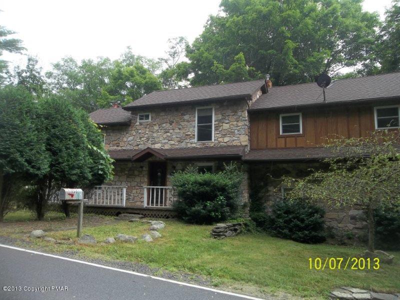 130 Donaldson Road Cresco, PA 18326 - Photo 1 of 20 a front view of a house with garden