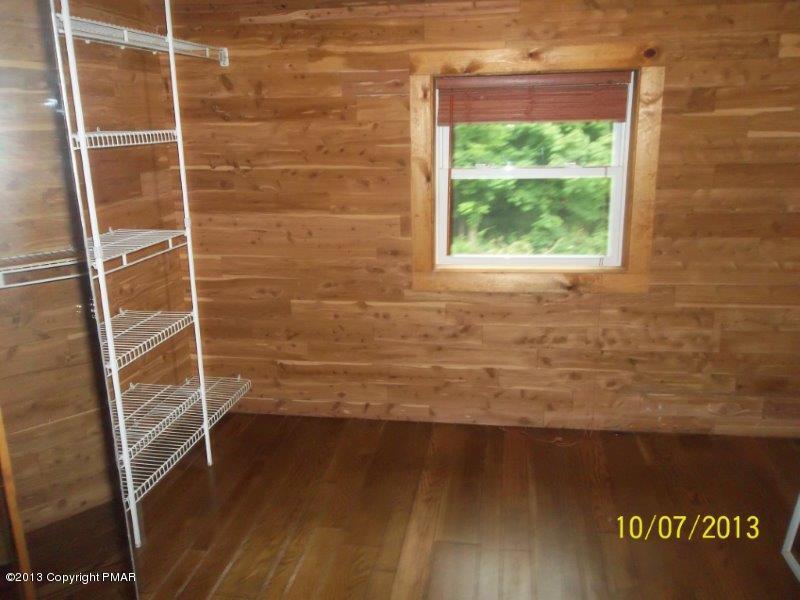 130 Donaldson Road Cresco, PA 18326 - Photo 11 of 20 a view of an empty room with wooden floor and a window