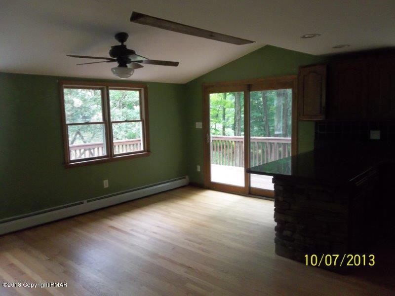 130 Donaldson Road Cresco, PA 18326 - Photo 3 of 20 a view of an empty room with a window and wooden floor